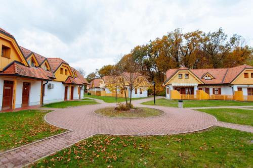 a brick walkway through a yard with houses at Apartments Prekmurska vas - Vital Resort in Moravske Toplice