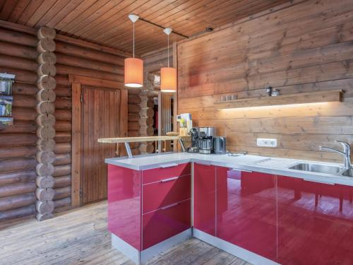 a kitchen with wooden walls and a counter with a sink at im Brixental II in Wörgl