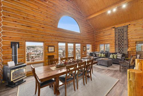a living room with a table and a fireplace at Spruce Lodge in Red Lodge