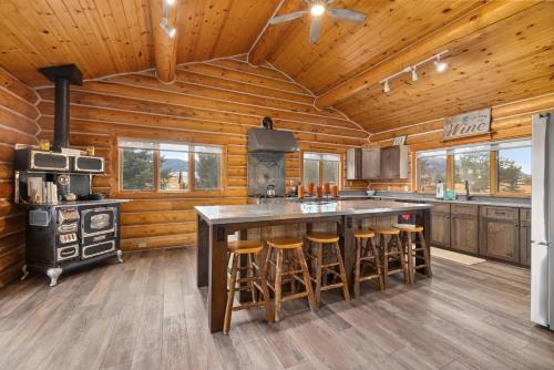 a kitchen with a large island in a log cabin at Spruce Lodge in Red Lodge