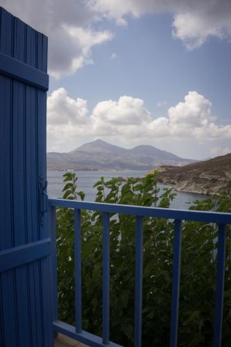 a view of the water from a blue door at Villa SOLEIL in Adamas