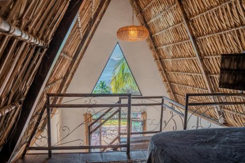 a bedroom with a balcony with a large window at Hotel y Restaurante Buganvilias in Las Aradas