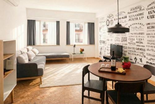 a living room with a table and a couch at The Lisbonaire Apartments in Lisbon