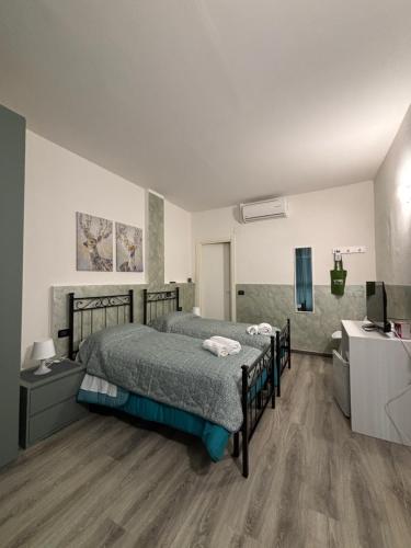 a bedroom with a bed and a television in it at Affittacamere Casa Lucia in La Spezia