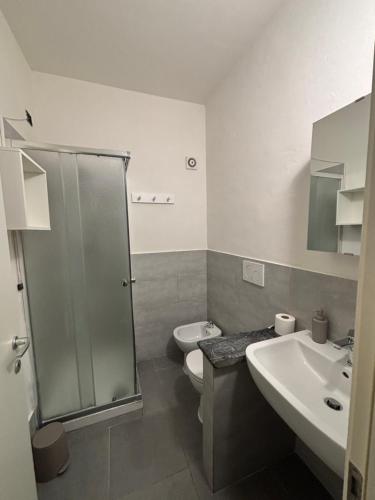 a bathroom with two sinks and a toilet and a shower at Affittacamere Casa Lucia in La Spezia