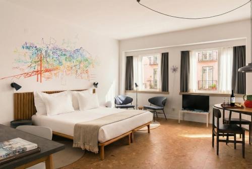 a hotel room with a bed and a desk at The Lisbonaire Apartments in Lisbon