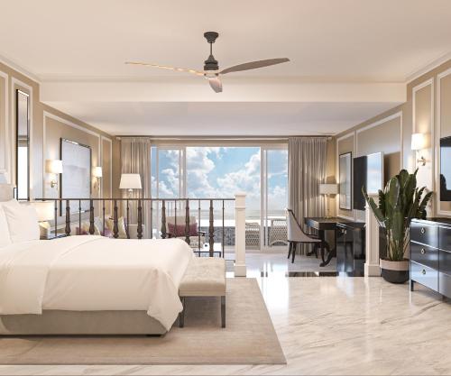 a bedroom with a bed and a balcony with a desk at The Grand Resort Rarotonga - Adults Only in Rarotonga