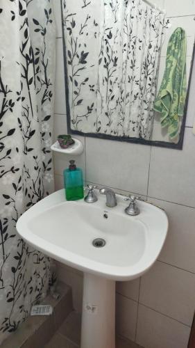 a bathroom with a white sink and a mirror at Casita de descanso in Pueblo Esther