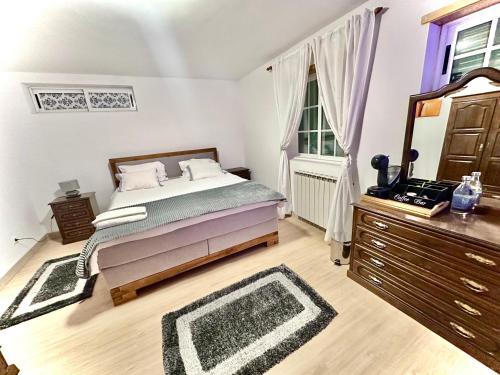 a bedroom with a bed and a dresser and a mirror at Quarto Eixo Atlântico in Bragança