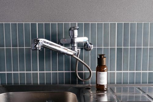 a kitchen sink with a blow dryer and a bottle of soap at 松本市の一棟貸しのプライベート邸宅 in Matsumoto