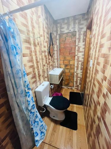 a bathroom with a toilet and a sink at Hotel Big Burg in Breves
