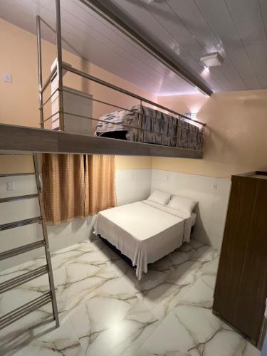 a bedroom with a bunk bed and a ladder at APART HOTEL Wm in Belém