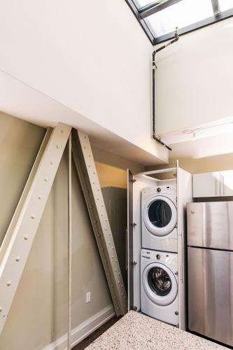 a laundry room with a washer and dryer at Downtown Luxury 2BR Penthouse Loft - Sleeps 6-8 in Milwaukee