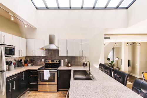 a kitchen with black and white cabinets and a counter top at Downtown Luxury 2BR Penthouse Loft - Sleeps 6-8 in Milwaukee