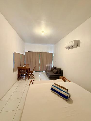 a bedroom with a bed and a living room at Solara Gili Air in Gili Islands