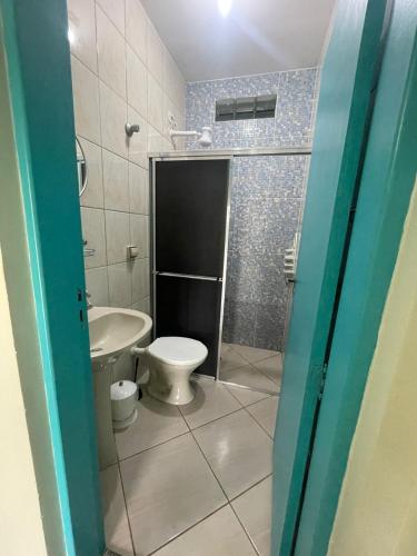 a bathroom with a toilet and a sink at Pousada Morada dos Guarás in Ilha Comprida