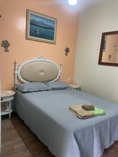 a bedroom with a bed with a towel on it at Pousada Morada dos Guarás in Ilha Comprida