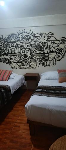 a bedroom with two beds and a wall with graffiti at AMARU Palace in Machu Picchu