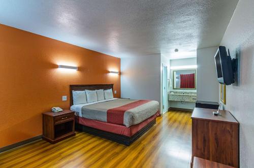 a hotel room with a bed and a flat screen tv at EXPRESS INN Troy in Troy