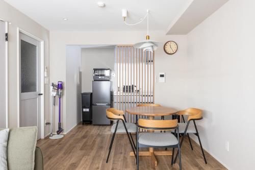a kitchen and dining room with a table and chairs at The Residence Sapporo - すすきの駅から徒歩6分 - in Sapporo