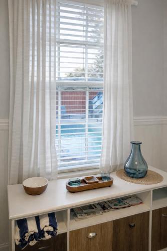a table with a window and a bowl on it at Relaxing Poolside Condo in Savannah