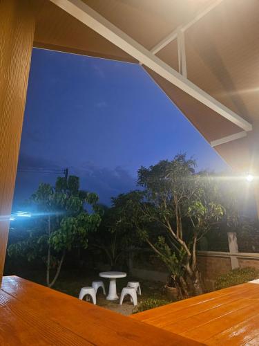 a room with a window with a table and trees at Khiri&Kiwi homestay in Ban Mae Rim Nua