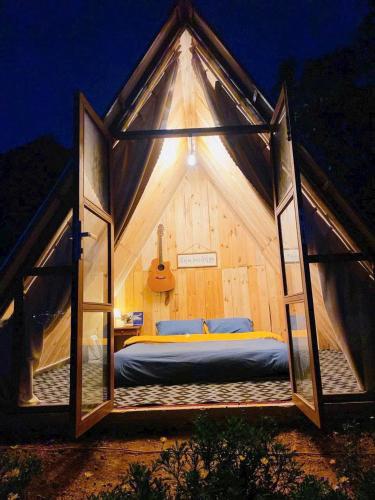 a room with a bed inside of a tent at An House in Xuân Trường