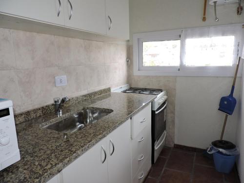 a kitchen with a sink and a stove at Pucom Pai in San Bernardo