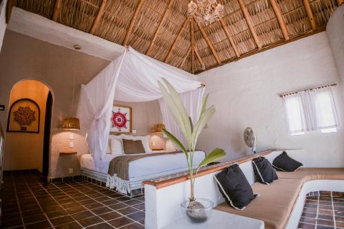 a bedroom with a bed and a couch in a room at baXar in Pie de la Cuesta