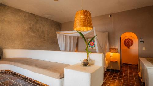 a room with a bed and a potted plant in it at baXar in Pie de la Cuesta