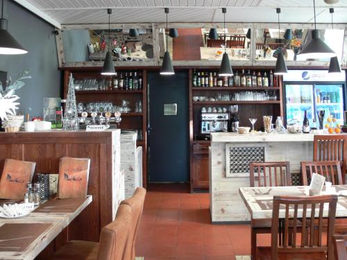 a restaurant with wooden tables and chairs and a bar at Hotel Na Baste in Jablonec nad Nisou