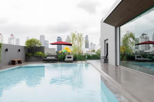 a swimming pool on the roof of a building at Shine 43 Service Residence Bangkok in Bangkok
