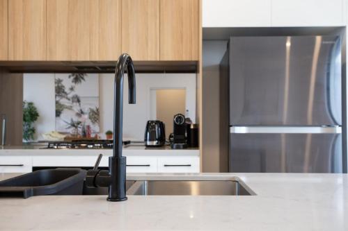 a kitchen with a sink and a faucet at Williamstown Townhouse in Williamstown