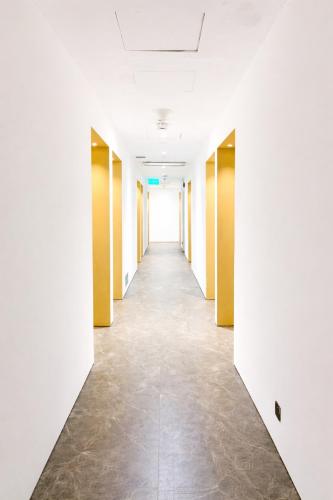 an empty corridor of an office building with white walls and a long hallway at A Hotel Dickson, Stay From 9PM To 8AM in Singapore