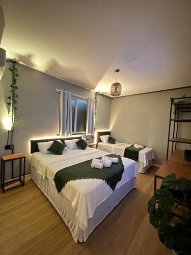 a large bedroom with two beds and a window at Vibe Amazon in Manaus