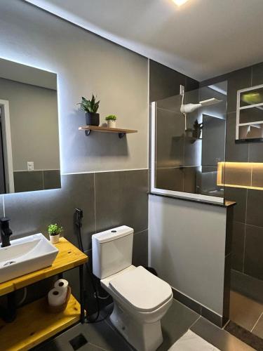 a bathroom with a white toilet and a sink at Vibe Amazon in Manaus