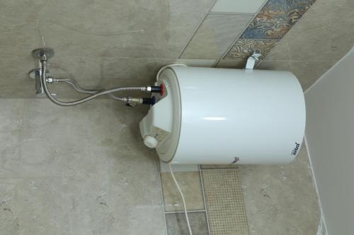 a toilet paper dispenser in a bathroom at Hotel Priso in Kālapettai