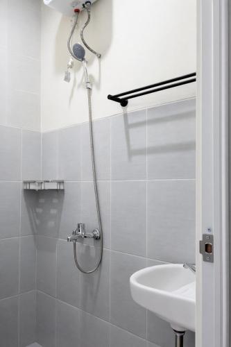 a bathroom with a shower and a sink at Diponegoro House Solo Baru in Solo