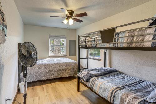 a bedroom with two bunk beds and a fan at Fish Sam Rayburn! Secluded Cabin w/ Deck & Grill in Brookeland