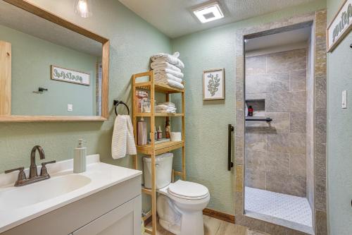 a bathroom with a toilet and a sink and a shower at Fish Sam Rayburn! Secluded Cabin w/ Deck & Grill in Brookeland