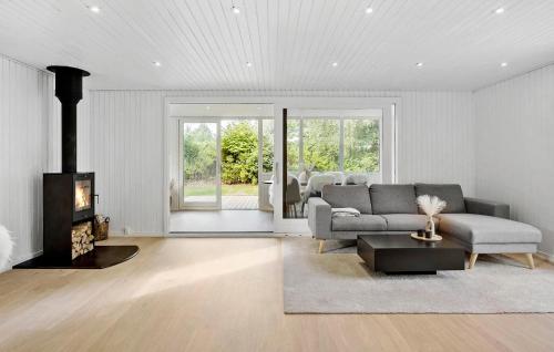 a living room with a couch and a fireplace at Nice Home In Farsø With House A Panoramic View in Farsø
