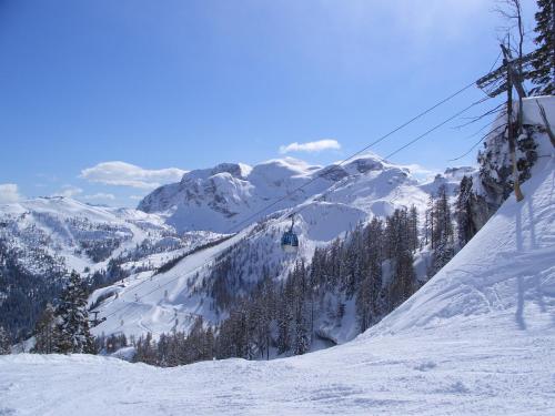 a ski lift going down a snow covered mountain at Biker Hotel Al Gallo Forcello in Passo Pramollo