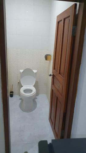 a bathroom with a toilet and a open door at Deva'sya Room Rent Nusa Dua in Nusa Dua
