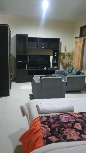 a living room with a couch and a fireplace at Deva'sya Room Rent Nusa Dua in Nusa Dua