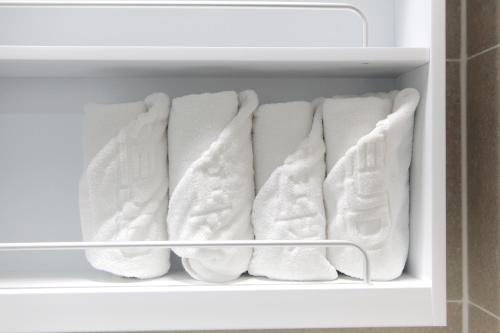 a refrigerator filled with lots of white towels at 서프리조트 양양 빅웨이브 in Yangyang