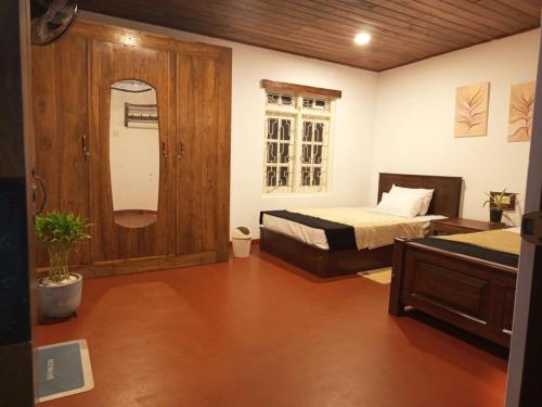 a bedroom with two beds and a window at Riverston view hostel in Matale