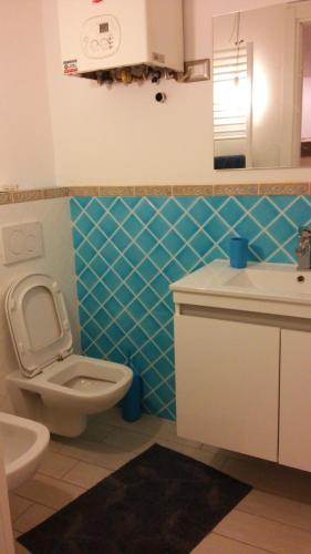a bathroom with a toilet and a sink at Casa Vacanze Zadina in Cesenatico