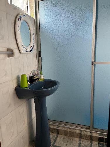 a bathroom with a blue sink and a mirror at Picaflor in Barra del Chuy