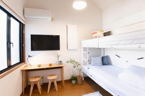 a bedroom with a bunk bed and a desk at Near Ikebukuro, Kitchen & Laundry, Fast Wi-Fi, 4min to Station,Many restaurants nearby!! in Tokyo