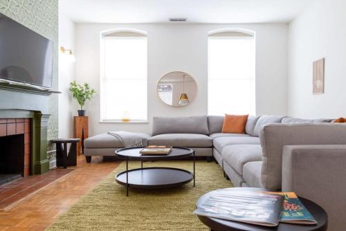 a living room with a couch and a table at Spacious Haven near Busch ABODEbucks in Soulard